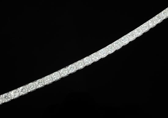 An attractive modern 18ct white gold and diamond line bracelet, 18cm.